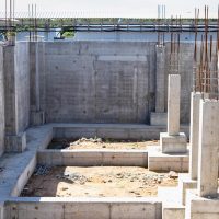 Construction of a monolithic concrete building. Modern monolithic construction. Reinforced concrete walls. Fendaments and grillages during the construction of the building